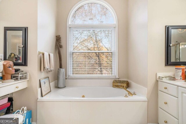 bathroom featuring a washtub and vanity