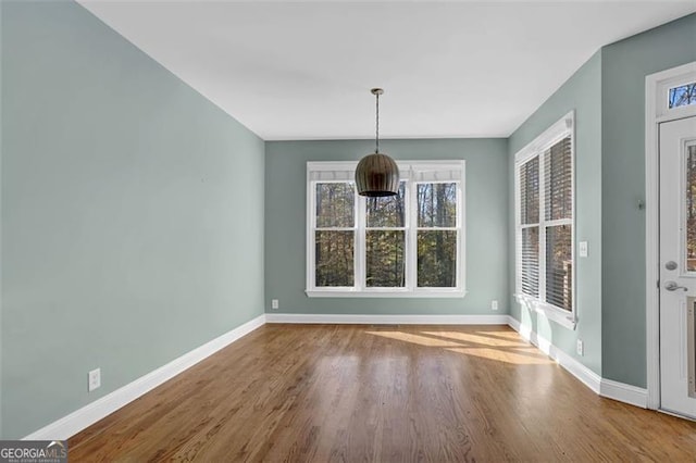 unfurnished dining area with hardwood / wood-style flooring