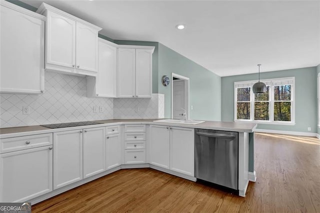 kitchen featuring white cabinets, light wood-type flooring, stainless steel dishwasher, and sink