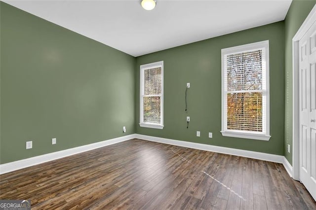 spare room with dark wood-type flooring