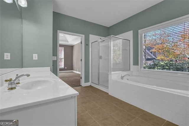 bathroom featuring tile patterned flooring, vanity, and shower with separate bathtub