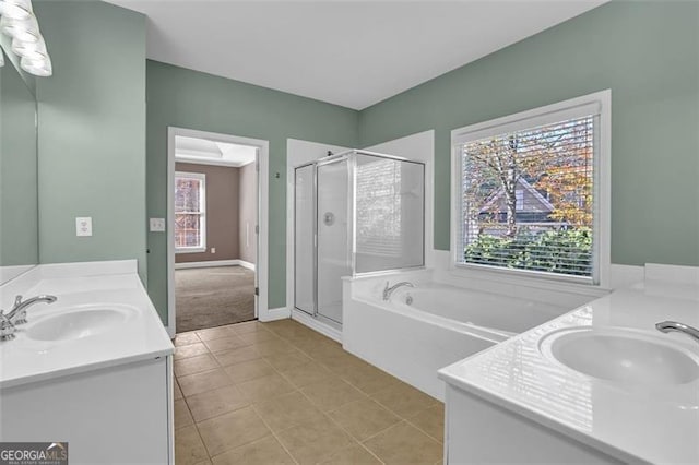 bathroom with tile patterned flooring, vanity, and a healthy amount of sunlight