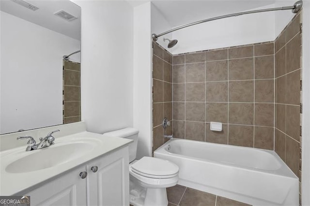 full bathroom featuring tile patterned floors, toilet, vanity, and tiled shower / bath