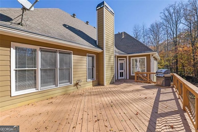 wooden terrace featuring grilling area