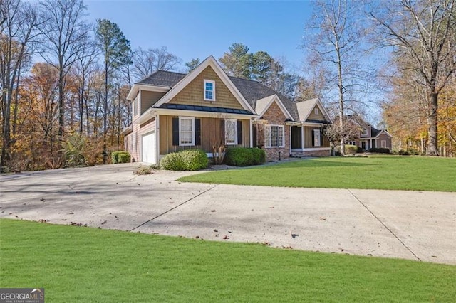 craftsman inspired home featuring a garage and a front lawn