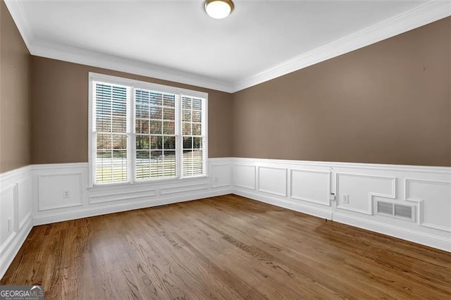 unfurnished room with wood-type flooring and ornamental molding