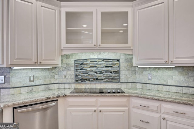 kitchen featuring backsplash, black electric cooktop, white cabinets, and stainless steel dishwasher