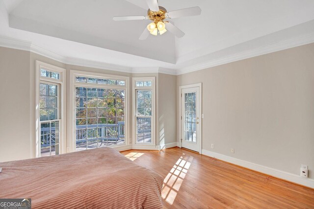 unfurnished bedroom with ceiling fan, light hardwood / wood-style flooring, access to outside, and multiple windows