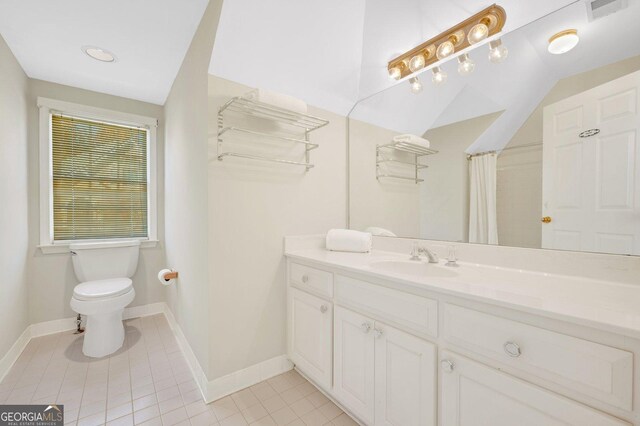 bathroom with tile patterned floors, curtained shower, vanity, and toilet