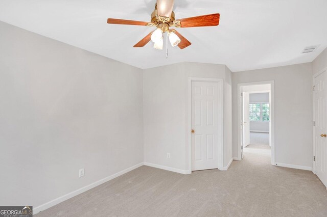 carpeted empty room with ceiling fan