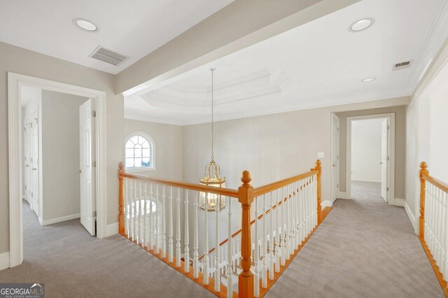 hall with light colored carpet and ornamental molding