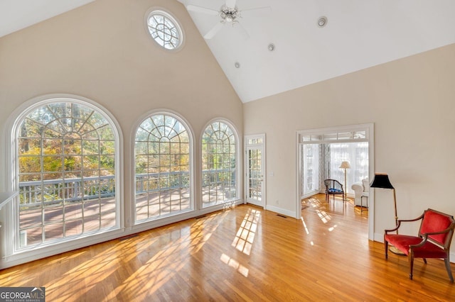 interior space featuring ceiling fan, light wood-type flooring, and high vaulted ceiling