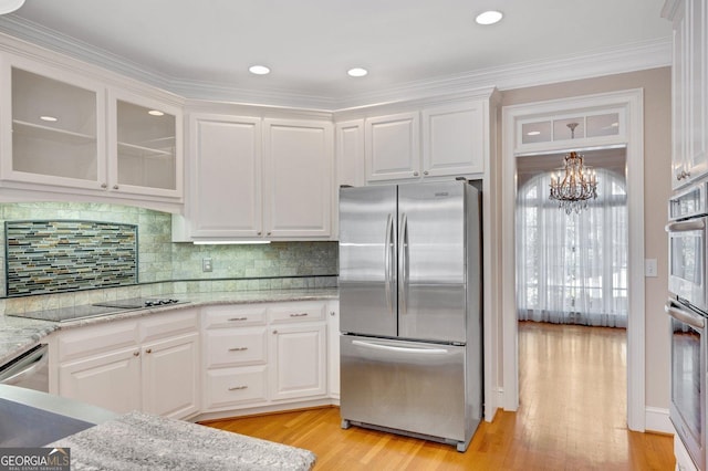 kitchen featuring crown molding, white cabinetry, light hardwood / wood-style flooring, and stainless steel appliances