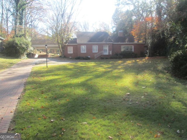 single story home featuring a front yard and a carport