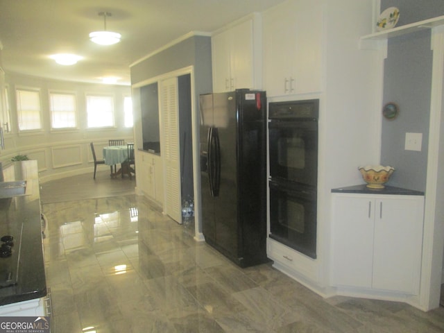 kitchen with black appliances and white cabinets