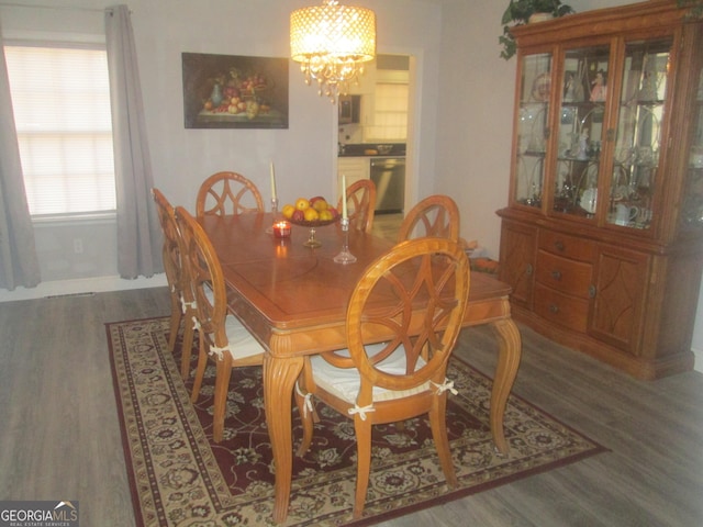 dining space with a chandelier and dark wood-type flooring