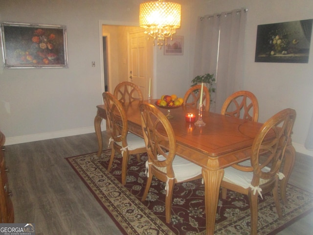 dining room featuring a chandelier and dark hardwood / wood-style floors