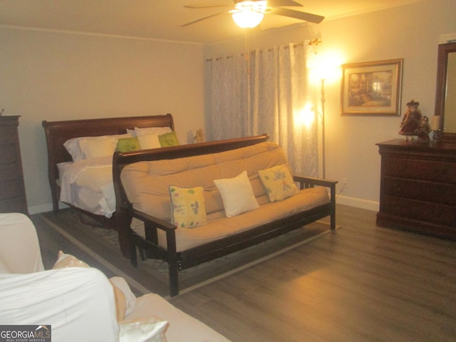 bedroom with ceiling fan, hardwood / wood-style floors, and crown molding