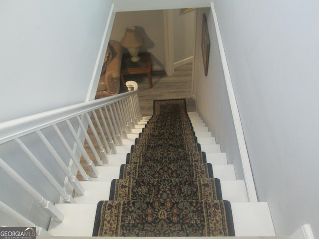 staircase with wood-type flooring