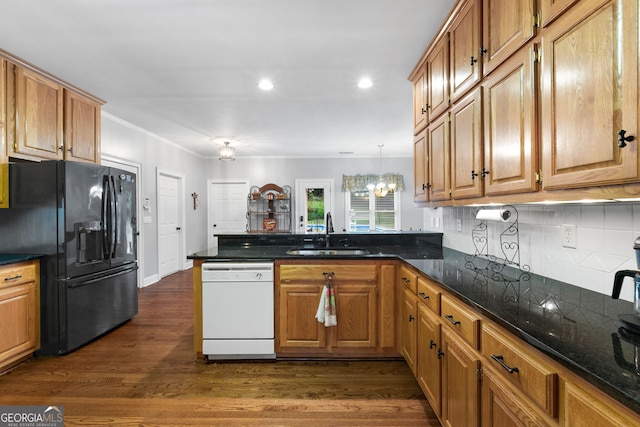 kitchen with dishwasher, black fridge, sink, and dark wood-type flooring