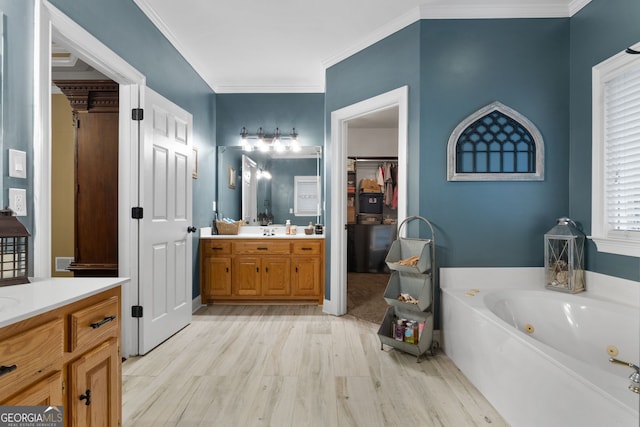 bathroom with a bath, crown molding, vanity, and wood-type flooring