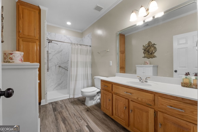 bathroom featuring ornamental molding, a shower with curtain, vanity, wood-type flooring, and toilet