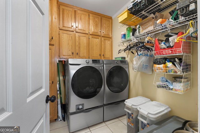 laundry room with cabinets, independent washer and dryer, and light tile patterned floors