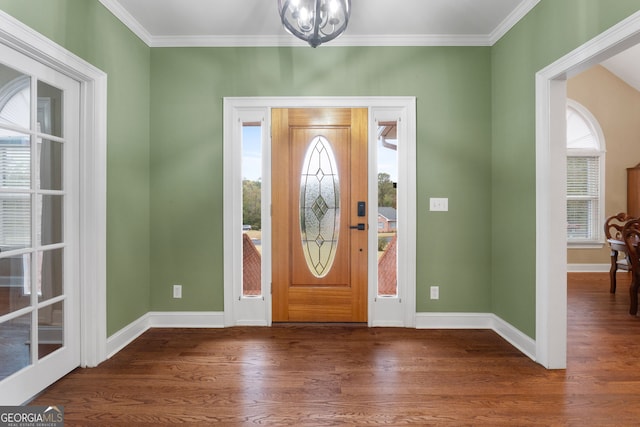 entrance foyer with plenty of natural light, dark hardwood / wood-style floors, and ornamental molding