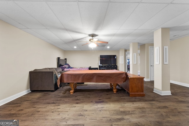 game room with a paneled ceiling, ceiling fan, dark wood-type flooring, and pool table