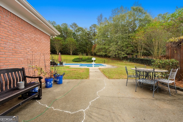 view of patio / terrace with a fenced in pool