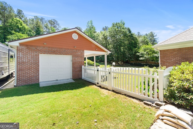 exterior space featuring an outdoor structure, a garage, and a yard