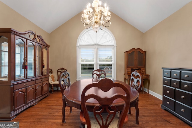 dining room with dark hardwood / wood-style floors, lofted ceiling, and a chandelier