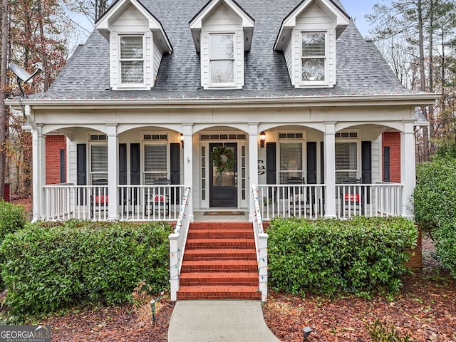 new england style home with a porch