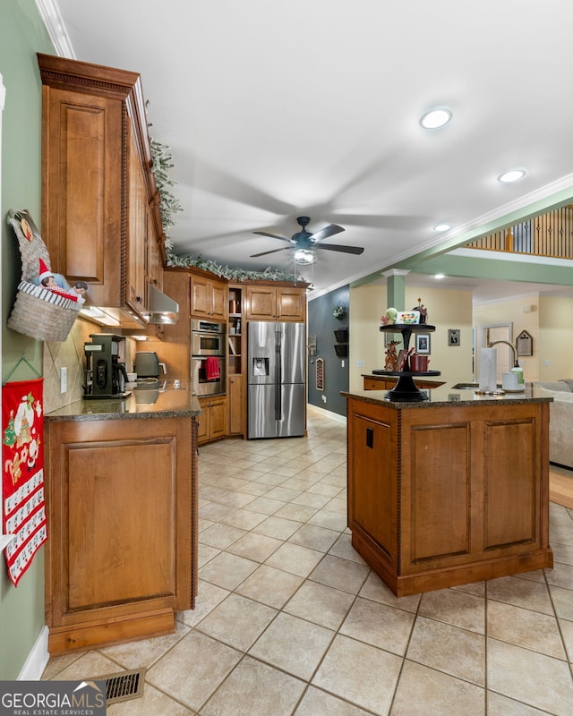 kitchen with ceiling fan, tasteful backsplash, crown molding, light tile patterned floors, and appliances with stainless steel finishes