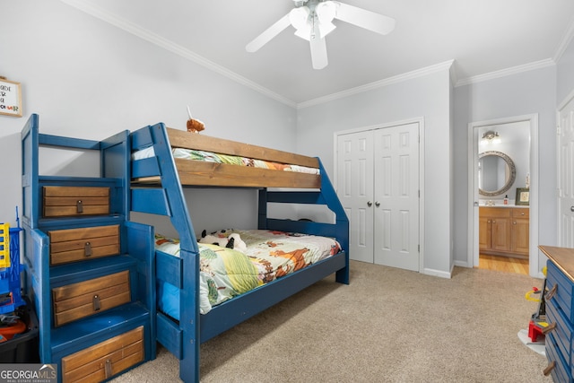 carpeted bedroom with connected bathroom, a closet, crown molding, and ceiling fan