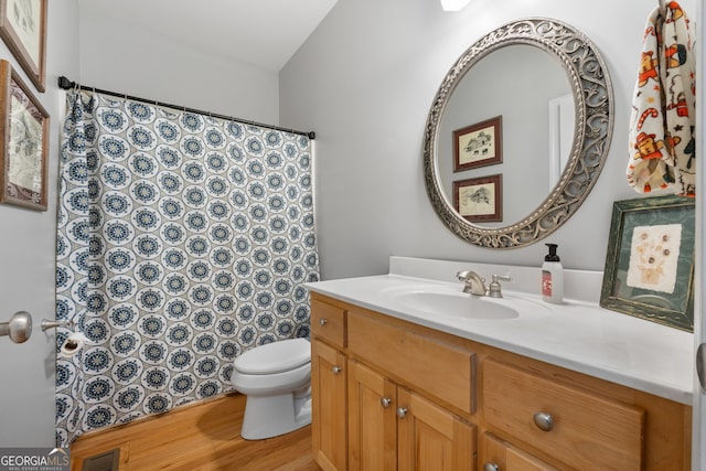 bathroom with hardwood / wood-style floors, vanity, and toilet