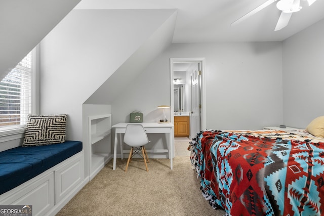 carpeted bedroom featuring ceiling fan, ensuite bathroom, and vaulted ceiling