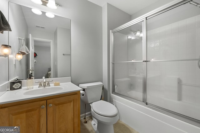 full bathroom with tile patterned flooring, vanity, toilet, and enclosed tub / shower combo