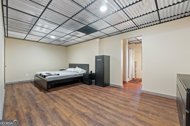 bedroom with dark hardwood / wood-style flooring