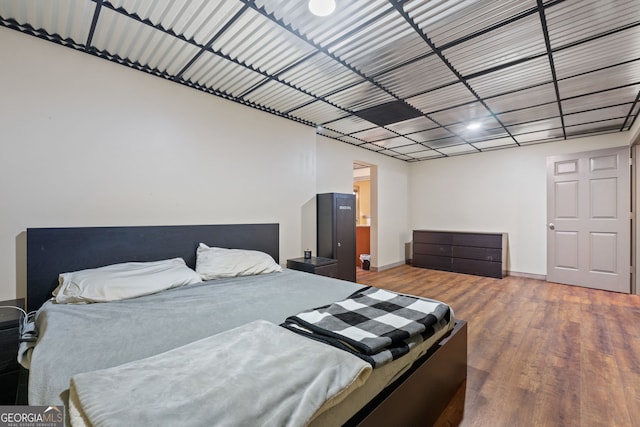 bedroom with wood-type flooring