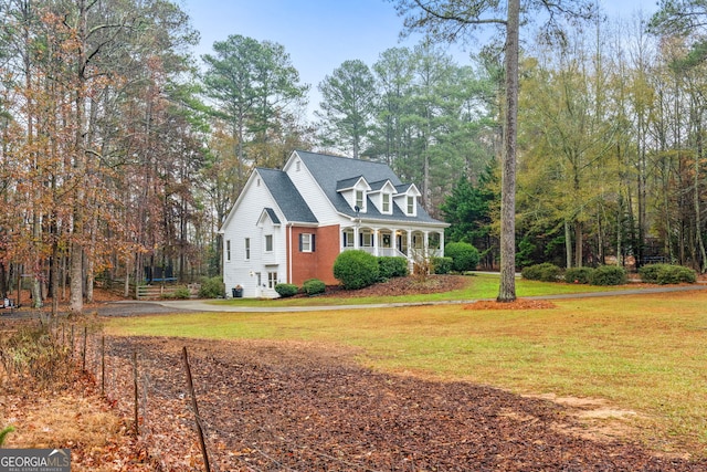 cape cod home with a front yard