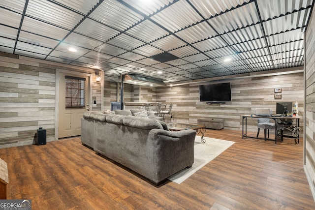 living room featuring wood-type flooring and wooden walls