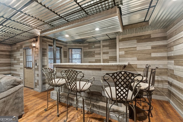 bar with wooden walls and wood-type flooring