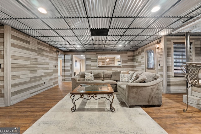 living room featuring wood-type flooring and wooden walls