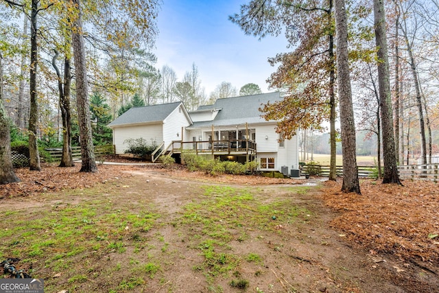 rear view of property with central AC and a deck