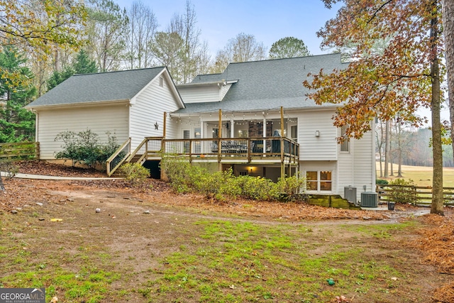 rear view of property with cooling unit and a deck