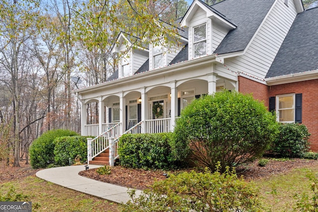 cape cod home featuring a porch