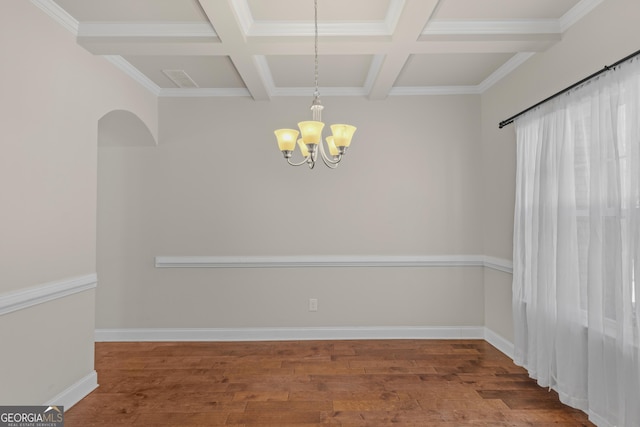 unfurnished dining area featuring coffered ceiling, hardwood / wood-style floors, and a notable chandelier