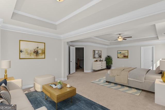 living room featuring a raised ceiling, ornamental molding, light colored carpet, and ceiling fan