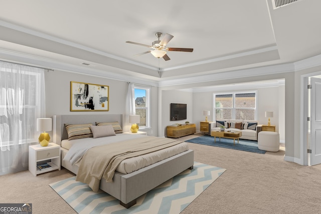 carpeted bedroom with multiple windows, ornamental molding, and a tray ceiling